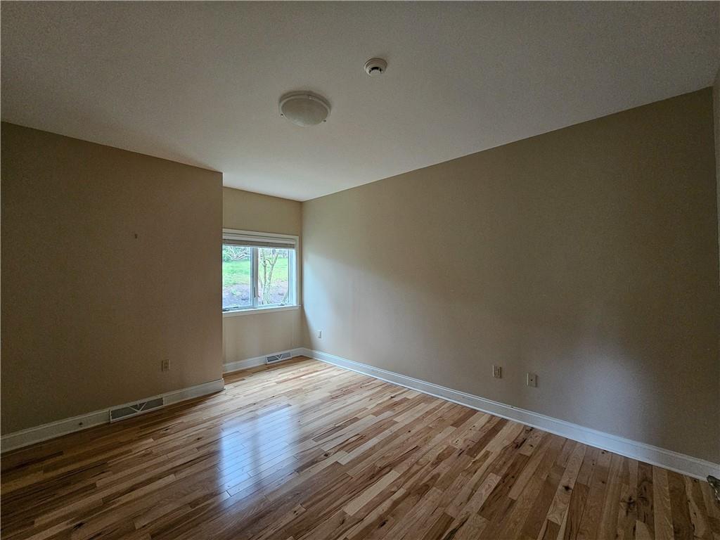 1845 Ferguson Road Allison Park, PA 15101 - Photo 35 of 50 a view of an empty room with wooden floor and a window