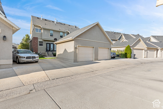 2092 Cres Drive South Mapleton, UT 84664 - Photo 26 of 26 Detached two-car garage with overhead doors, concrete driveway, and exterior wall lanterns
