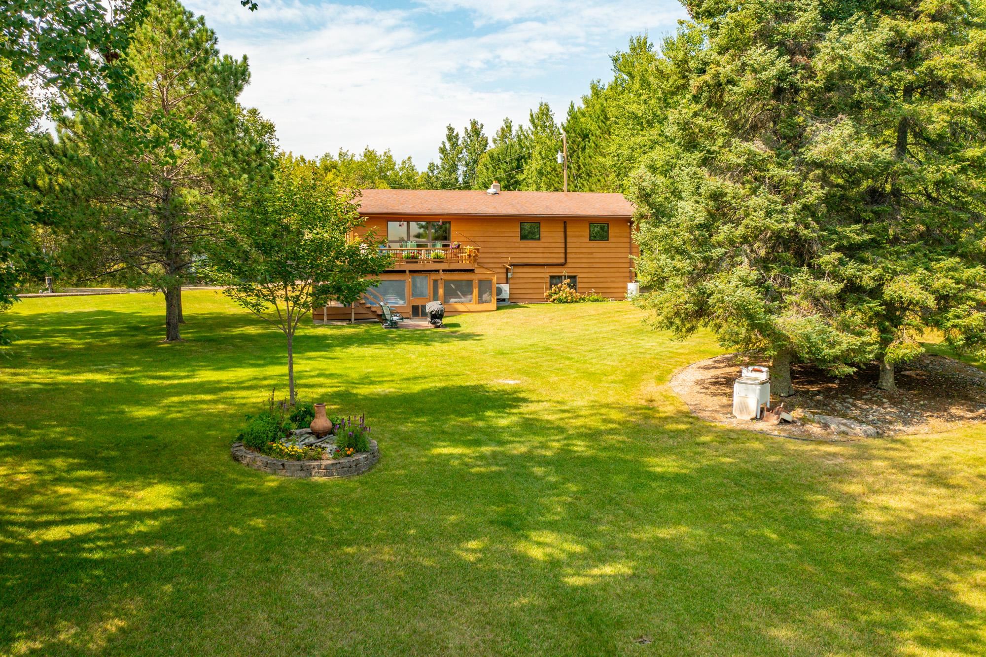 View of green lawn featuring a deck