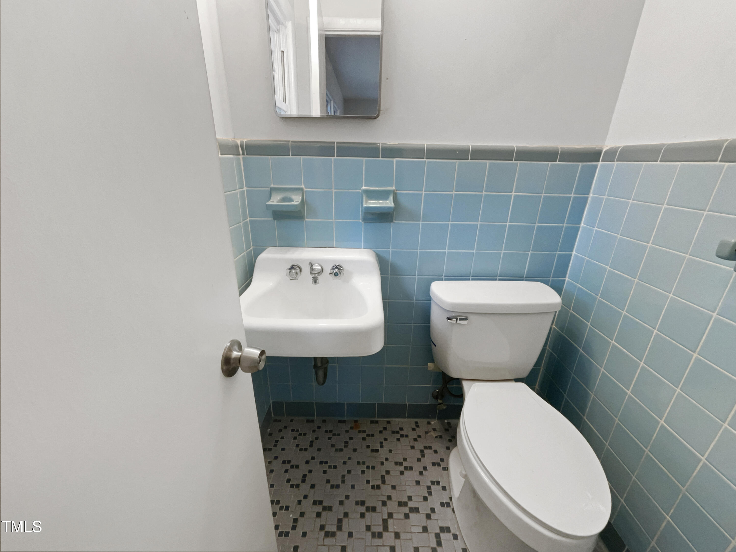 623 Sybil Drive Durham, NC 27703 - Photo 18 of 18 a bathroom with a toilet sink and mirror