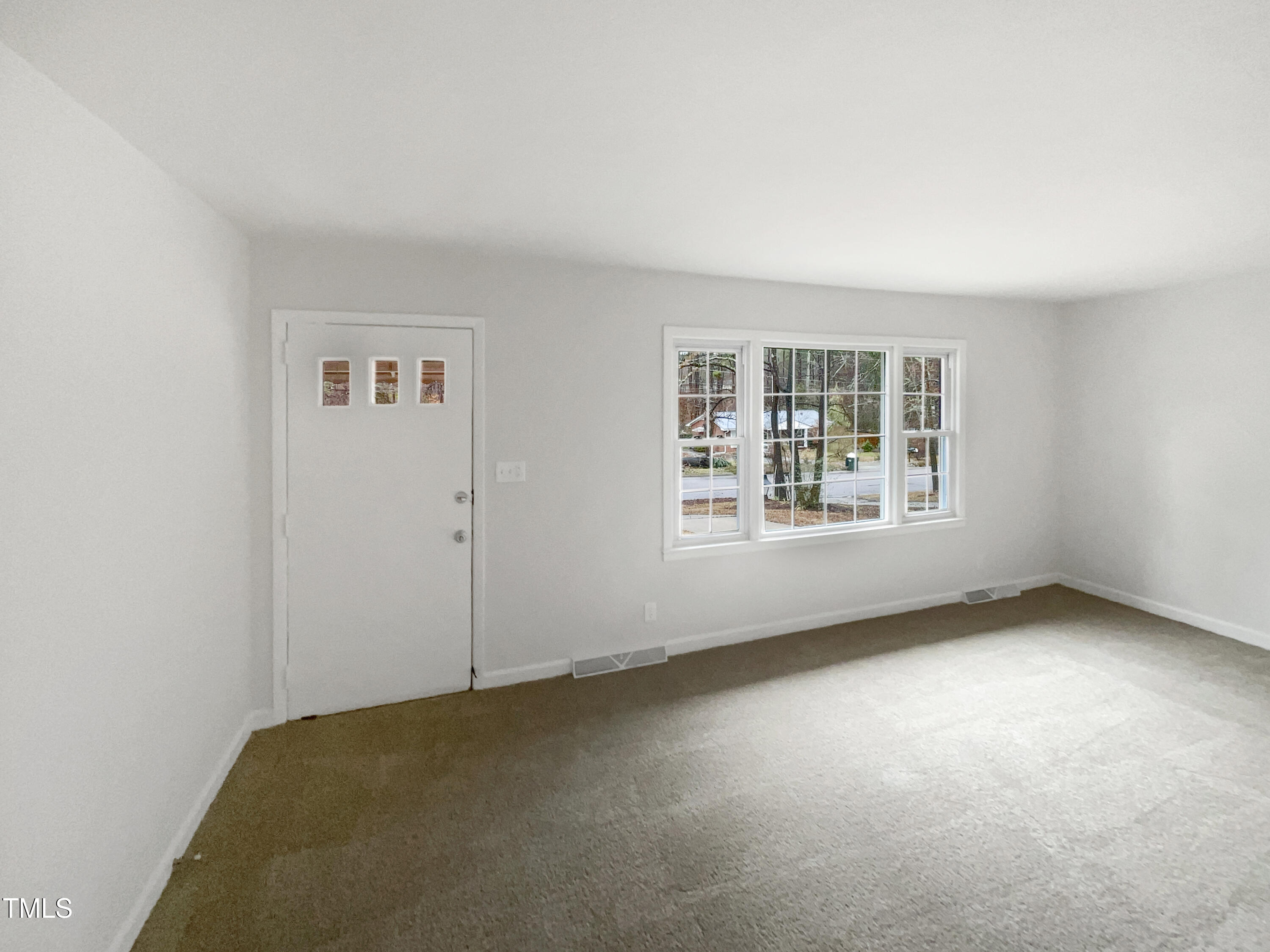 623 Sybil Drive Durham, NC 27703 - Photo 4 of 18 an empty room with windows