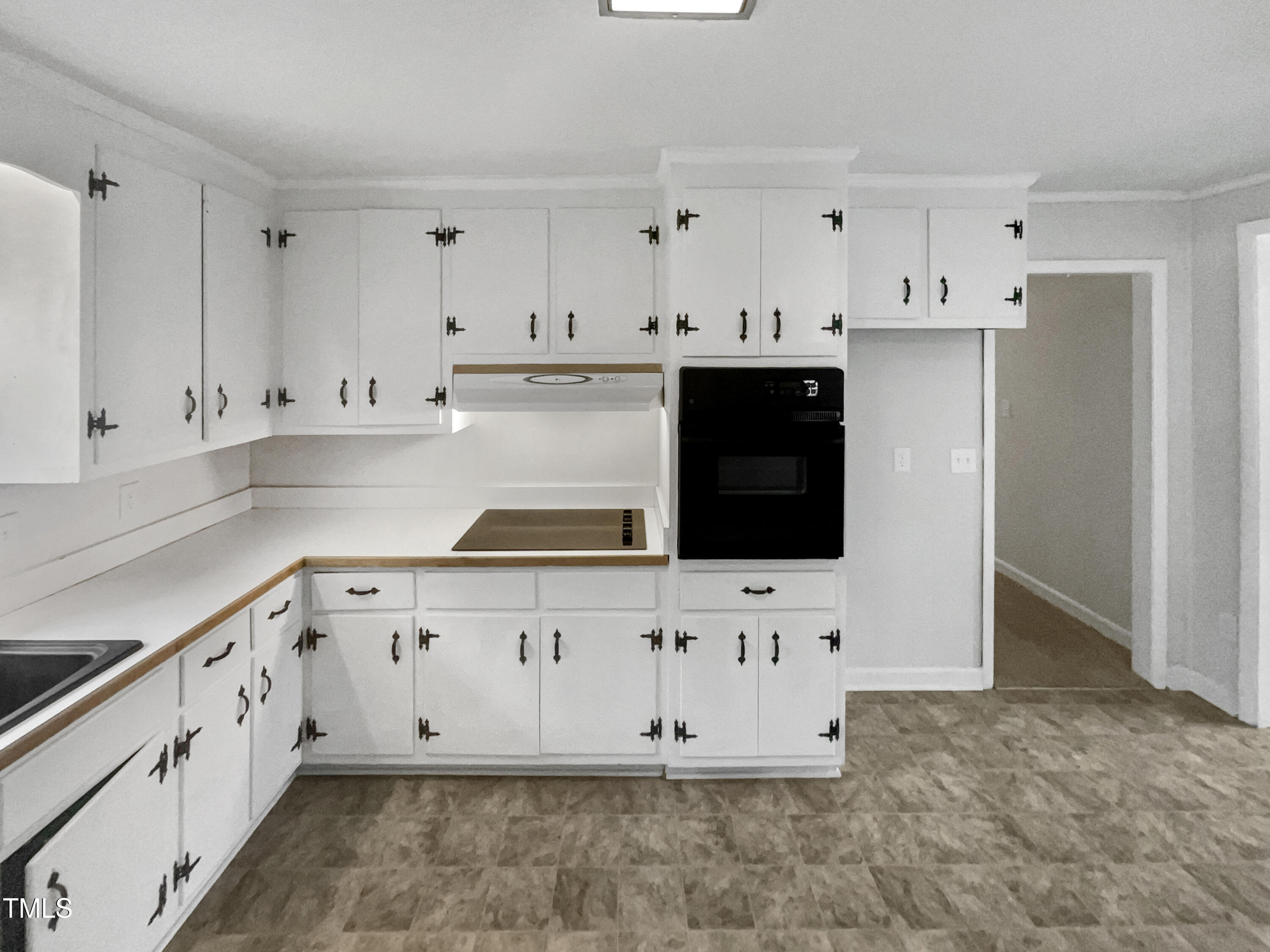 623 Sybil Drive Durham, NC 27703 - Photo 5 of 18 a kitchen with granite countertop white cabinets and stainless steel appliances