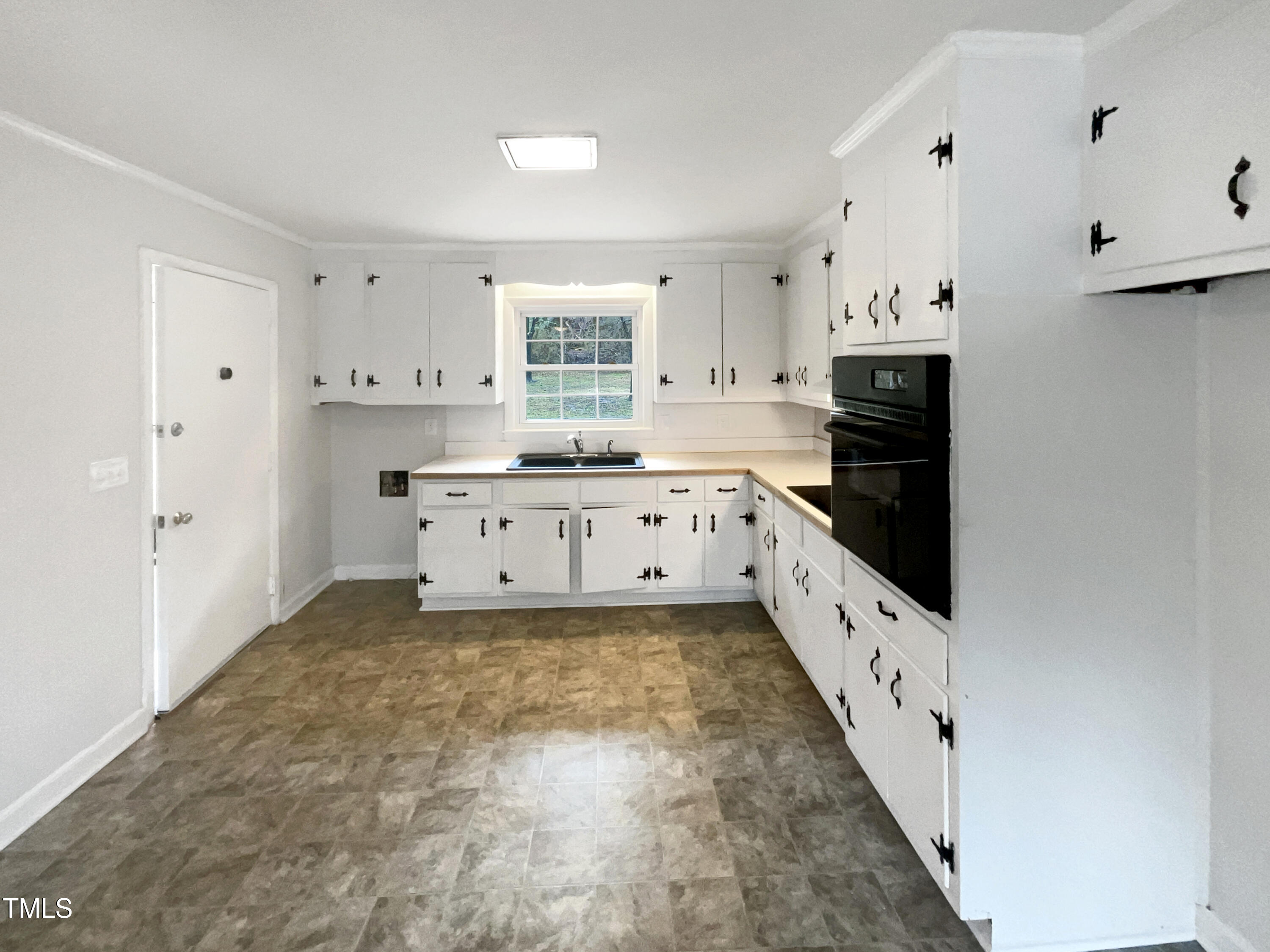 623 Sybil Drive Durham, NC 27703 - Photo 6 of 18 a kitchen with granite countertop a stove a sink and a refrigerator