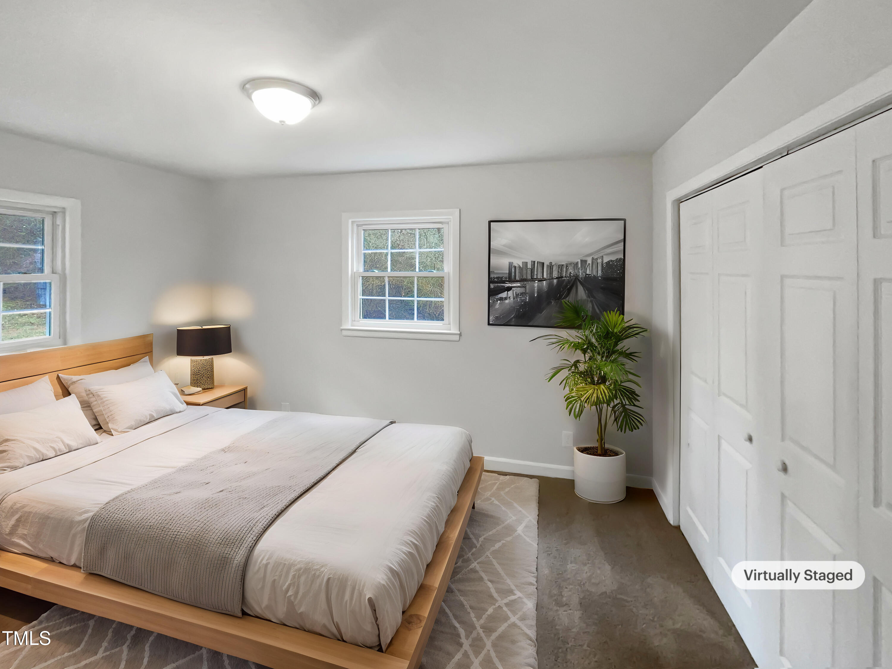 623 Sybil Drive Durham, NC 27703 - Photo 8 of 18 a bedroom with a bed and a potted plant