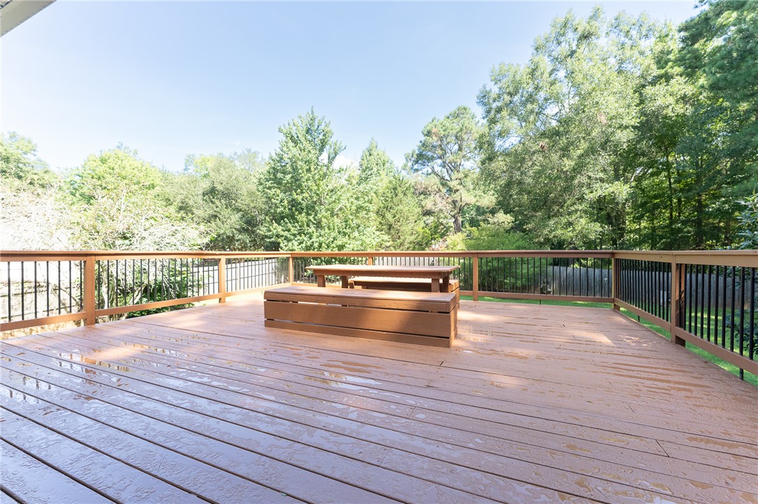 117 Shaftsbury Road Clemson, SC 29631 - Photo 6 of 29 An expansive wooden deck overlooks a private backyard surrounded by mature trees.