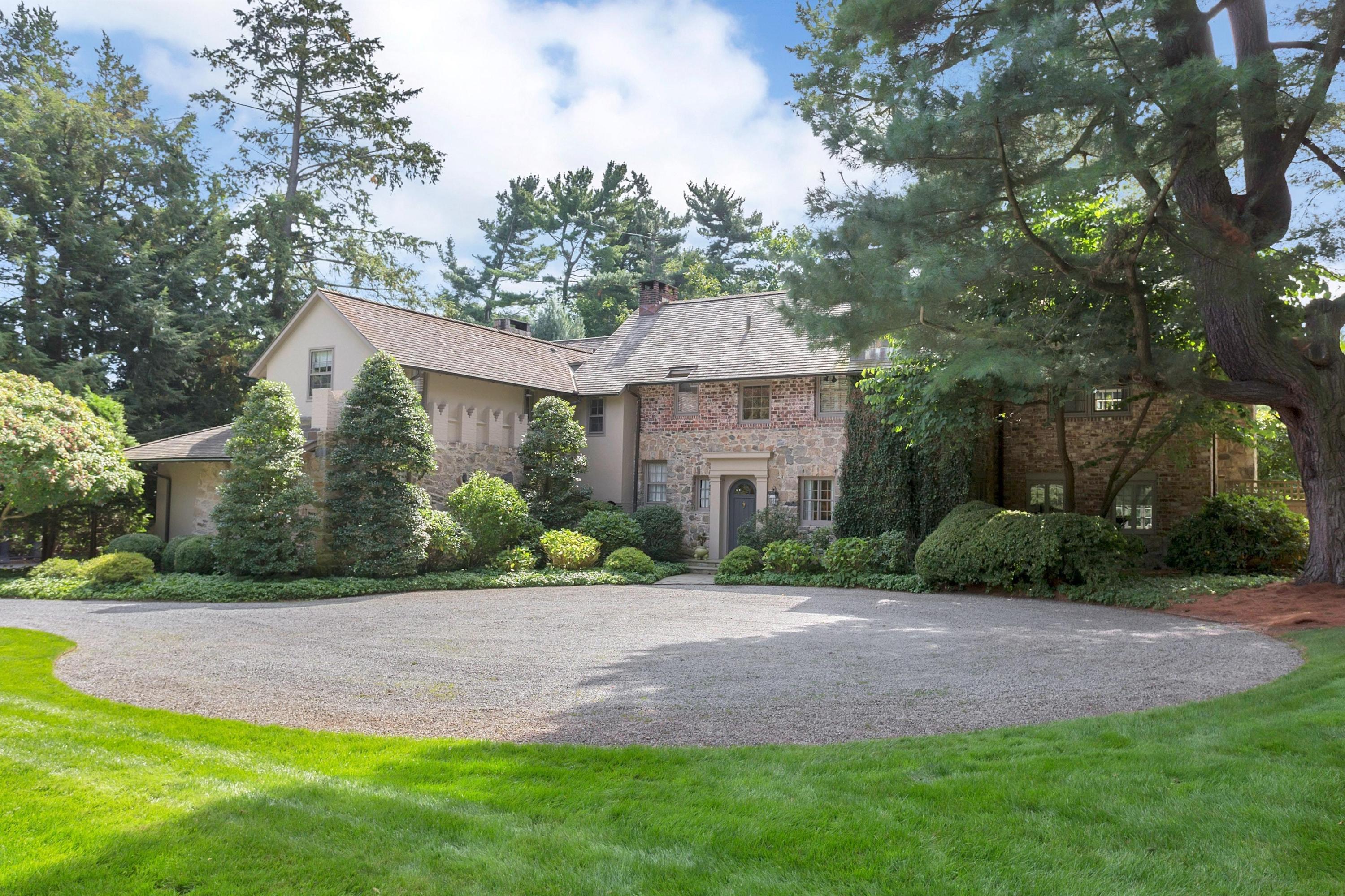 a front view of a house with a garden