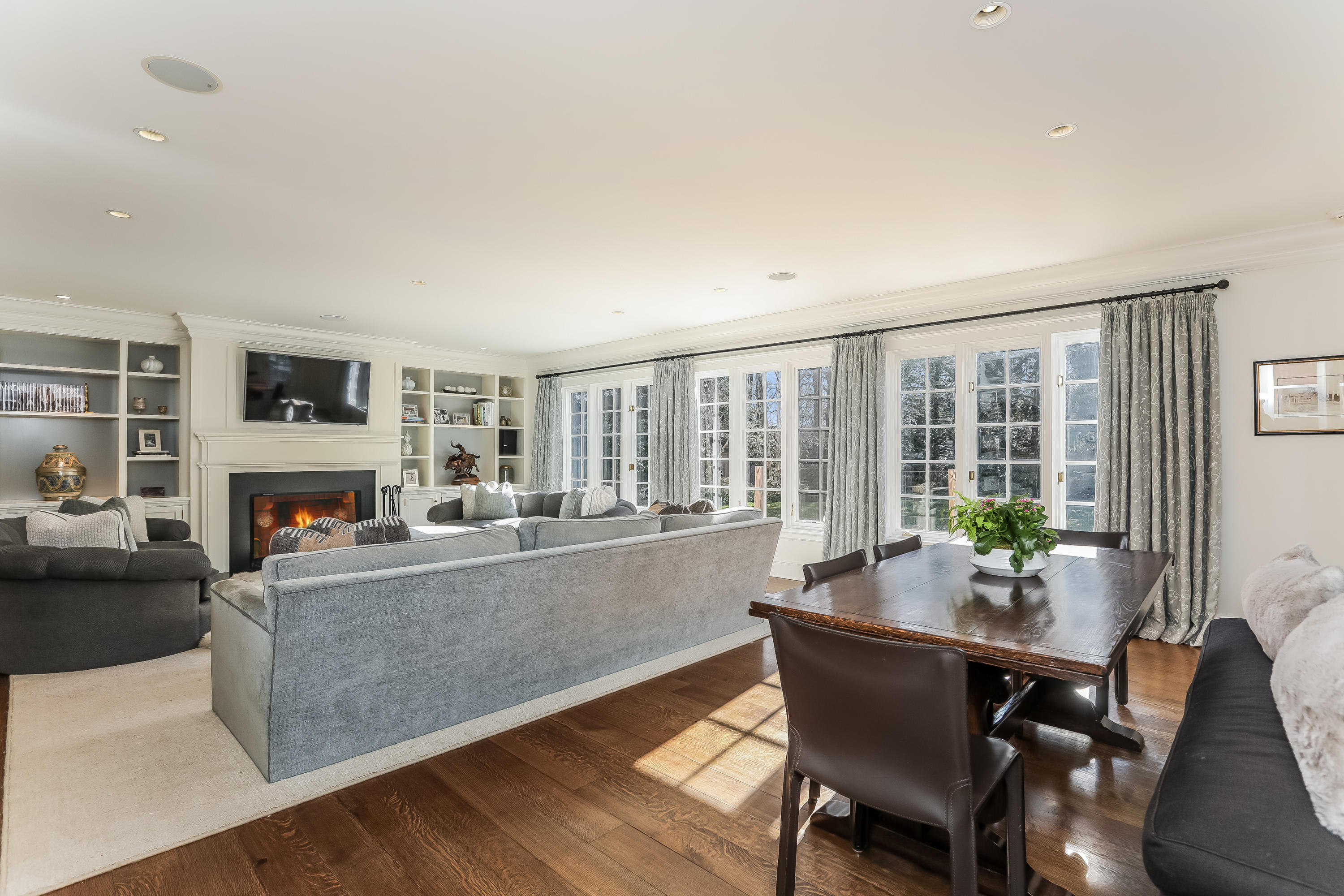 30 Old Farm Road Darien, CT 06820 - Photo 16 of 42 a living room with furniture a fireplace and a dining table with wooden floor