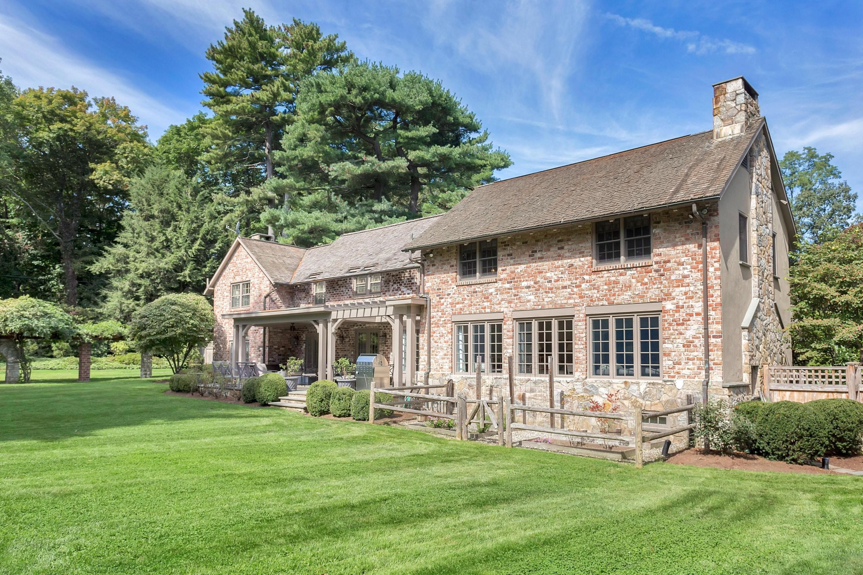 30 Old Farm Road Darien, CT 06820 - Photo 34 of 42 a front view of a house with a garden and trees