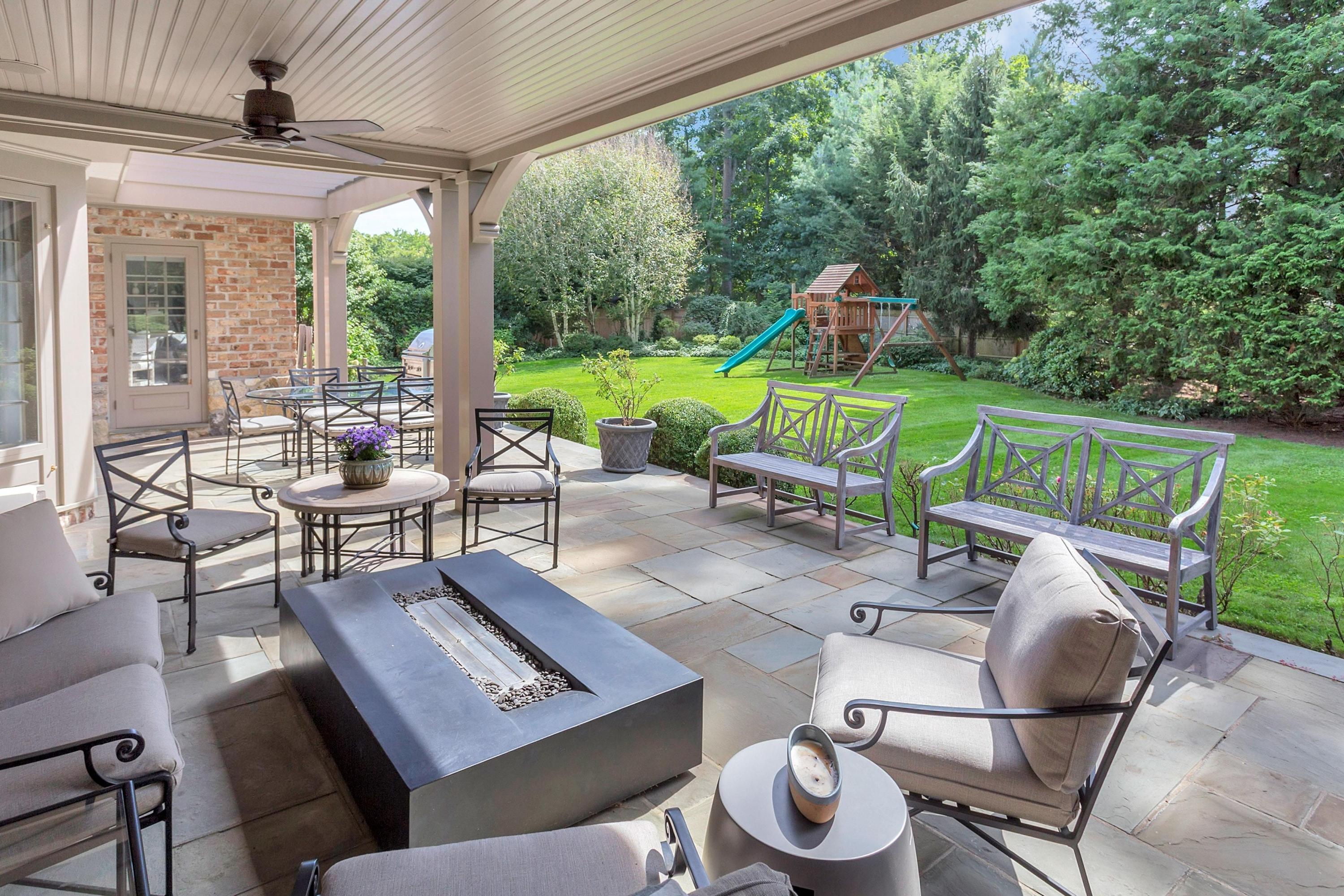 30 Old Farm Road Darien, CT 06820 - Photo 35 of 42 a view of a patio with couches chairs and a floor to ceiling window