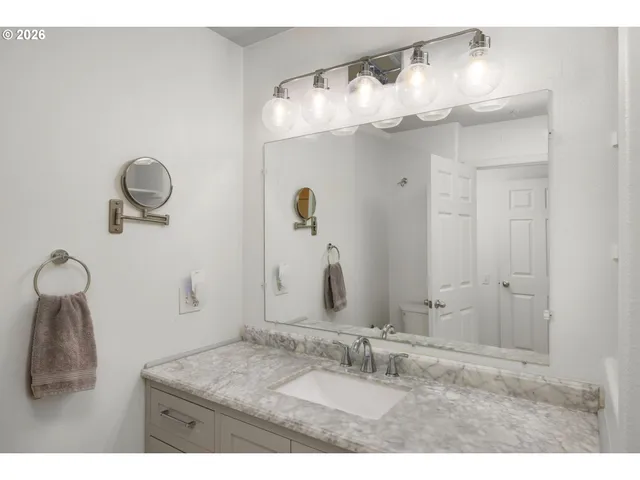 a bathroom with a sink vanity and a mirror