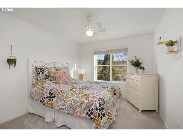 a bed sitting in a bedroom next to a window