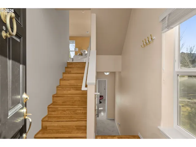 a view of entryway and hall with wooden floor
