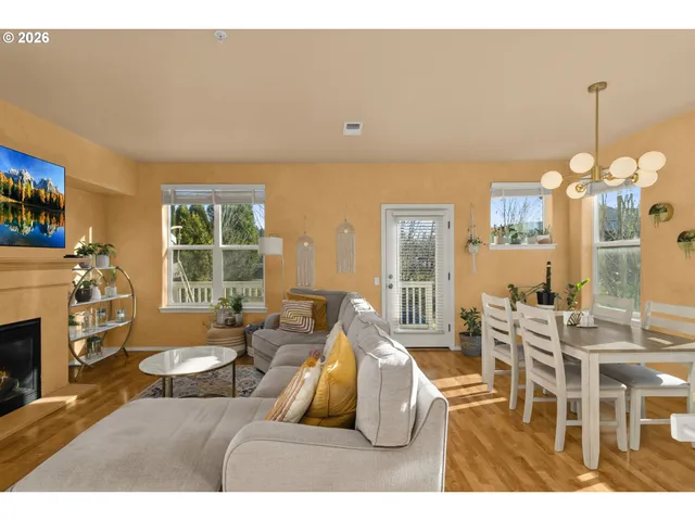 a living room with furniture a fireplace and a chandelier