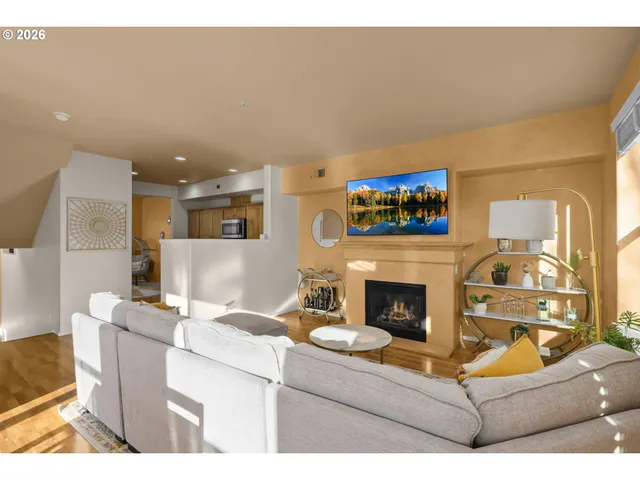 a living room with furniture a fireplace and a flat screen tv