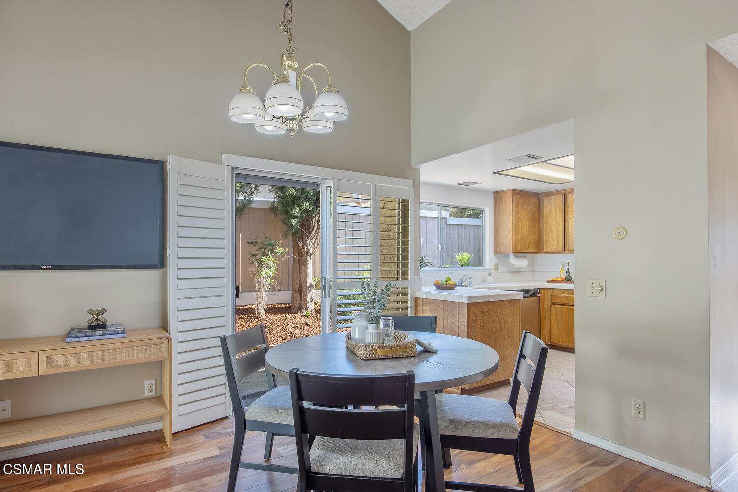 175 Conifer Circle Oak Park, CA 91377 - Photo 6 of 20 a dining room with wooden floor a chandelier a wooden table and chairs