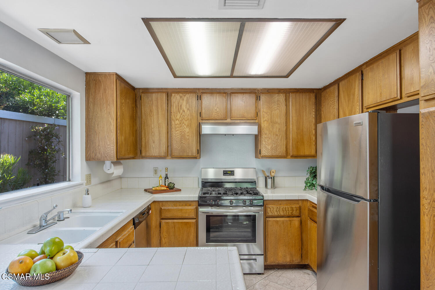 175 Conifer Circle Oak Park, CA 91377 - Photo 7 of 20 a kitchen with a refrigerator sink and cabinets