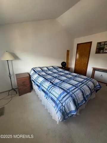 a bedroom with a bed and lamp