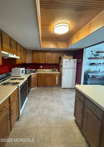 a kitchen with a stove a sink and a refrigerator