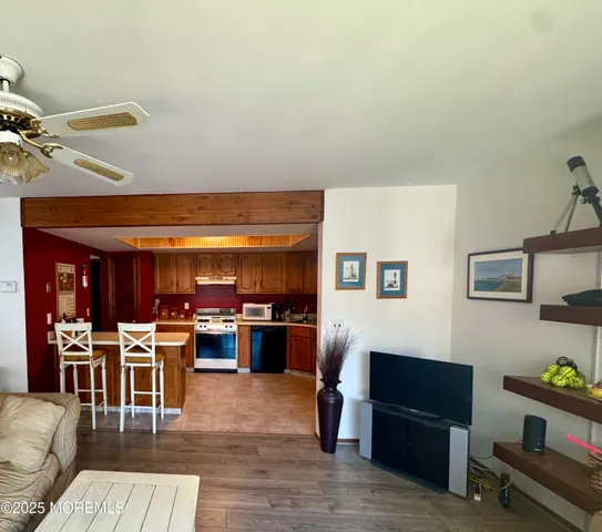 a living room with lots of furniture and kitchen view