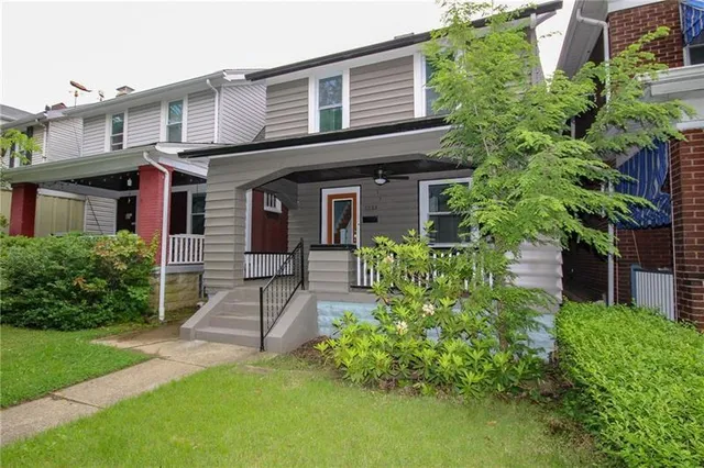 a front view of a house with garden