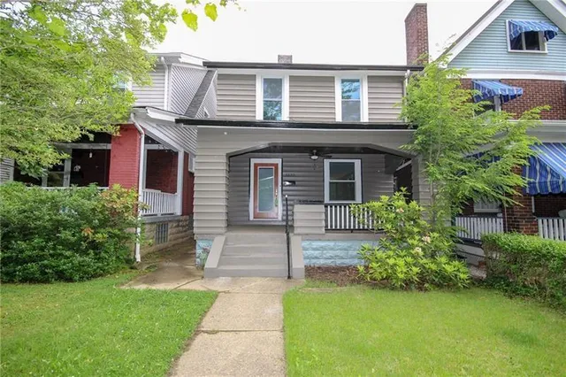a front view of a house with a garden