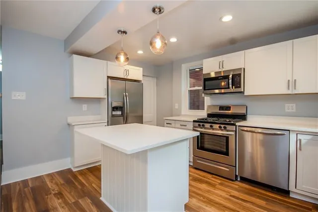 a kitchen with stainless steel appliances a sink stove and refrigerator