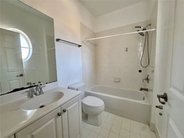 a bathroom with a sink toilet tub and shower