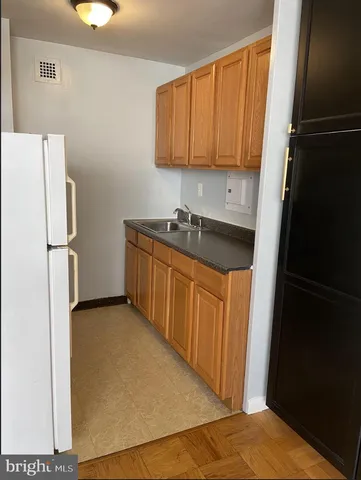 a kitchen with a refrigerator and cabinets