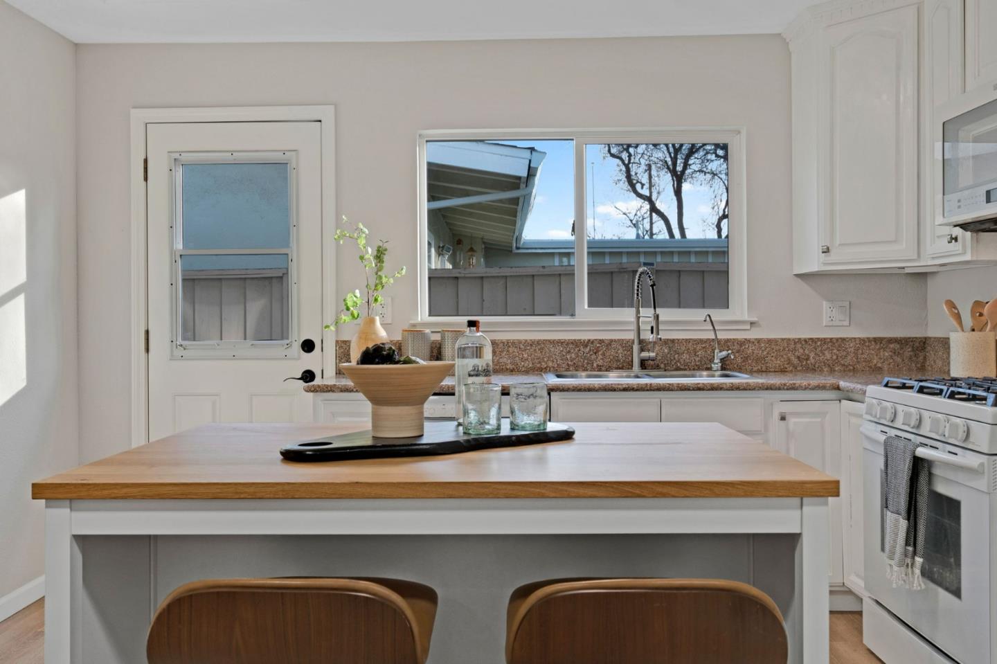 1775 Ravizza Avenue Santa Clara, CA 95051 - Photo 13 of 41 a kitchen with cabinets a window and stainless steel appliances