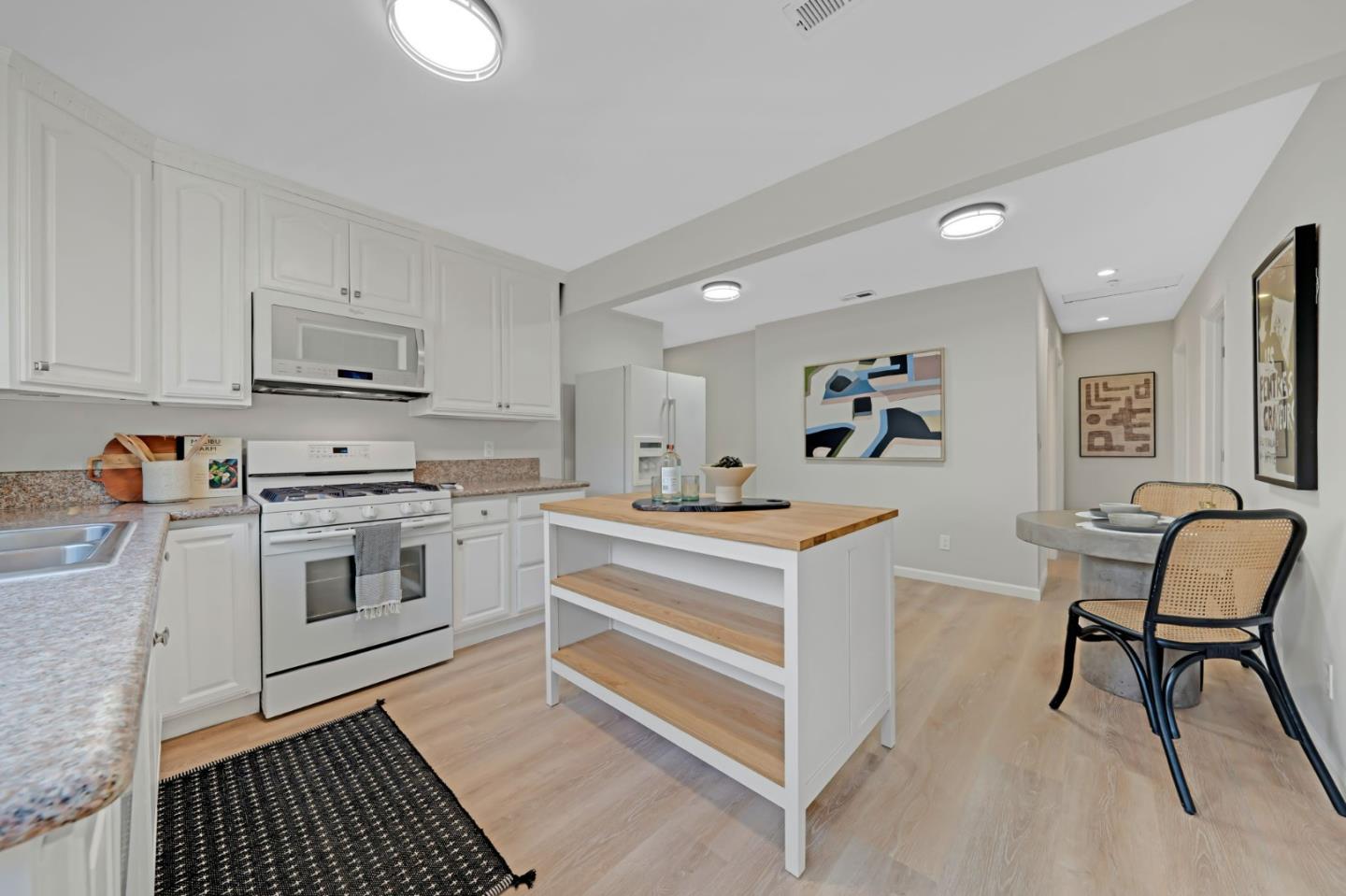 1775 Ravizza Avenue Santa Clara, CA 95051 - Photo 16 of 41 a kitchen with granite countertop white cabinets and white appliances