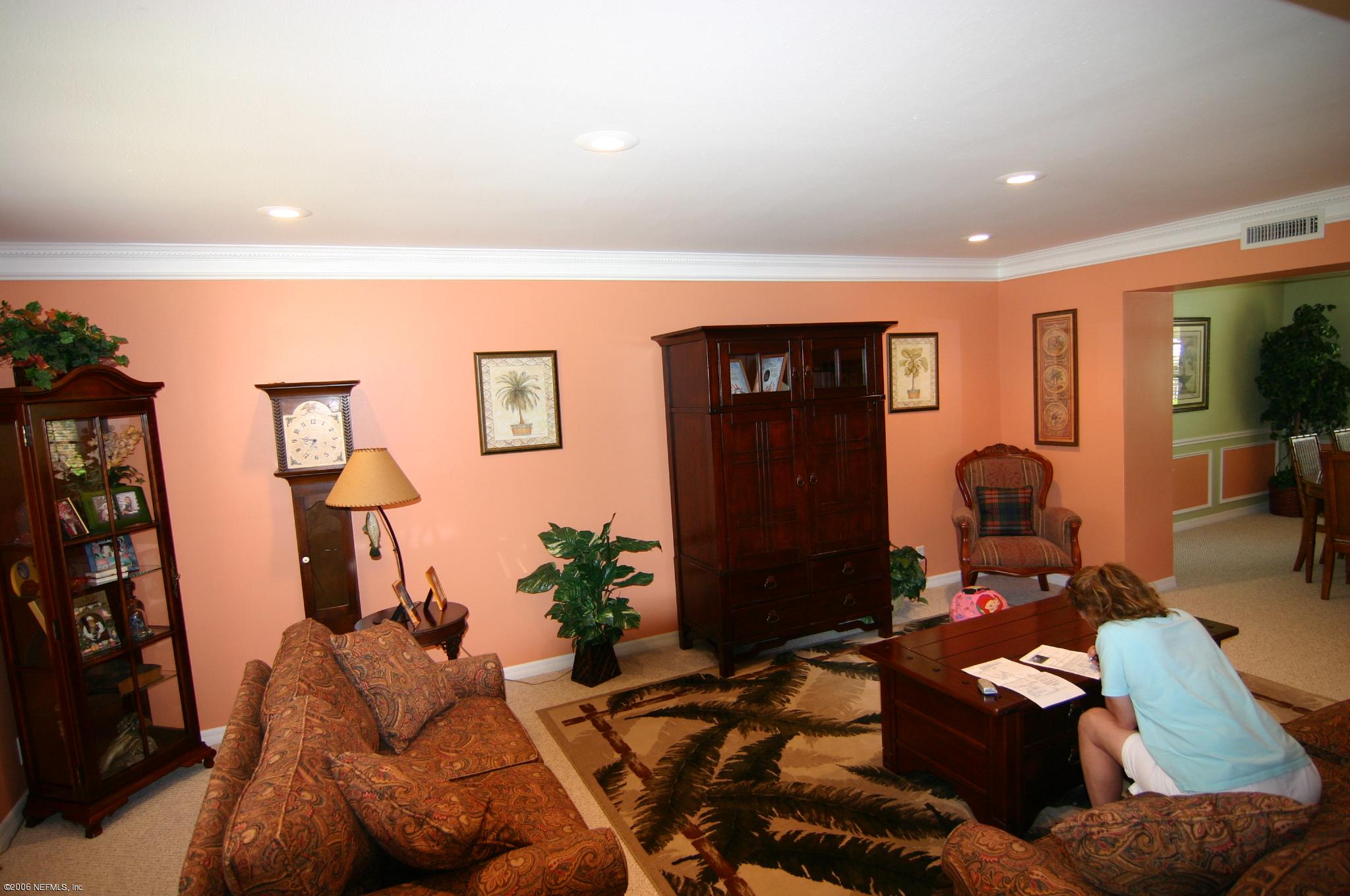 11743 Fort Caroline Road Jacksonville, FL 32225 - Photo 8 of 9 a living room with furniture and a large mirror