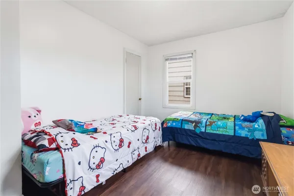 a bedroom with a bed and a dresser in it