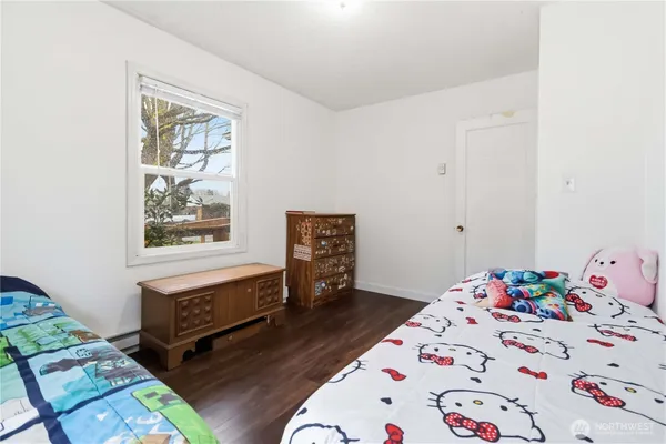 a bedroom with a bed and a television