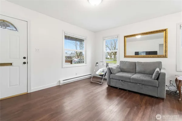 a living room with furniture and wooden floor