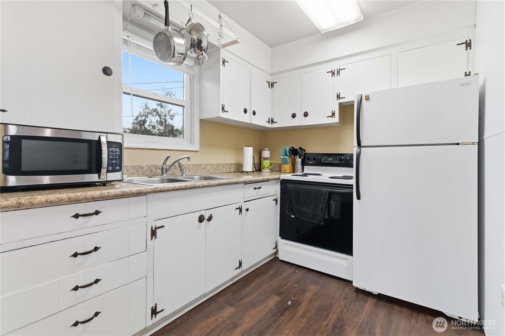 463 26th Avenue Longview, WA 98632 - Photo 10 of 28 a kitchen with stainless steel appliances a refrigerator stove and white cabinets