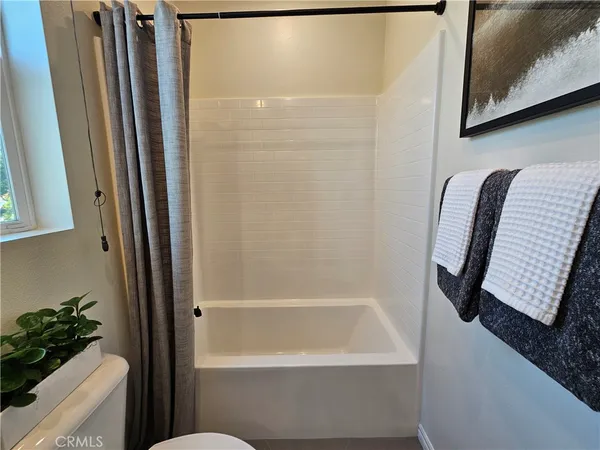 a bedroom with a bed and a tv