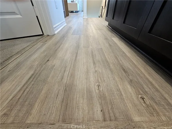 a view of a hallway to rooms and stairs