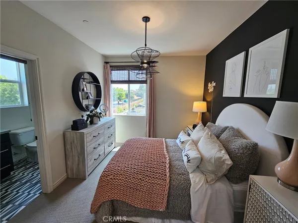 a bedroom with a bed and a potted plant