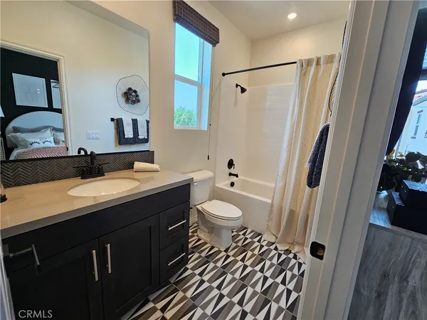 a bedroom with bed and a chandelier