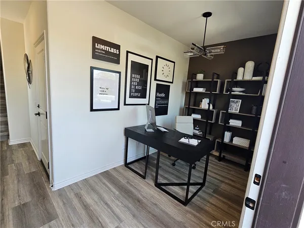 a view of a workspace with furniture and wooden floor