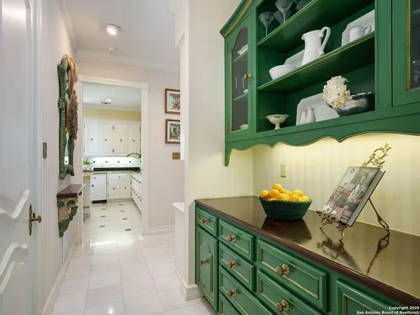 a kitchen with stainless steel appliances kitchen island granite countertop a sink a stove and white cabinets