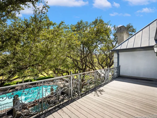 an aerial view of a house with a yard and swimming pool