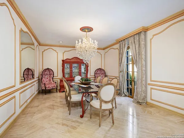 a view of a dining room with furniture and chandelier