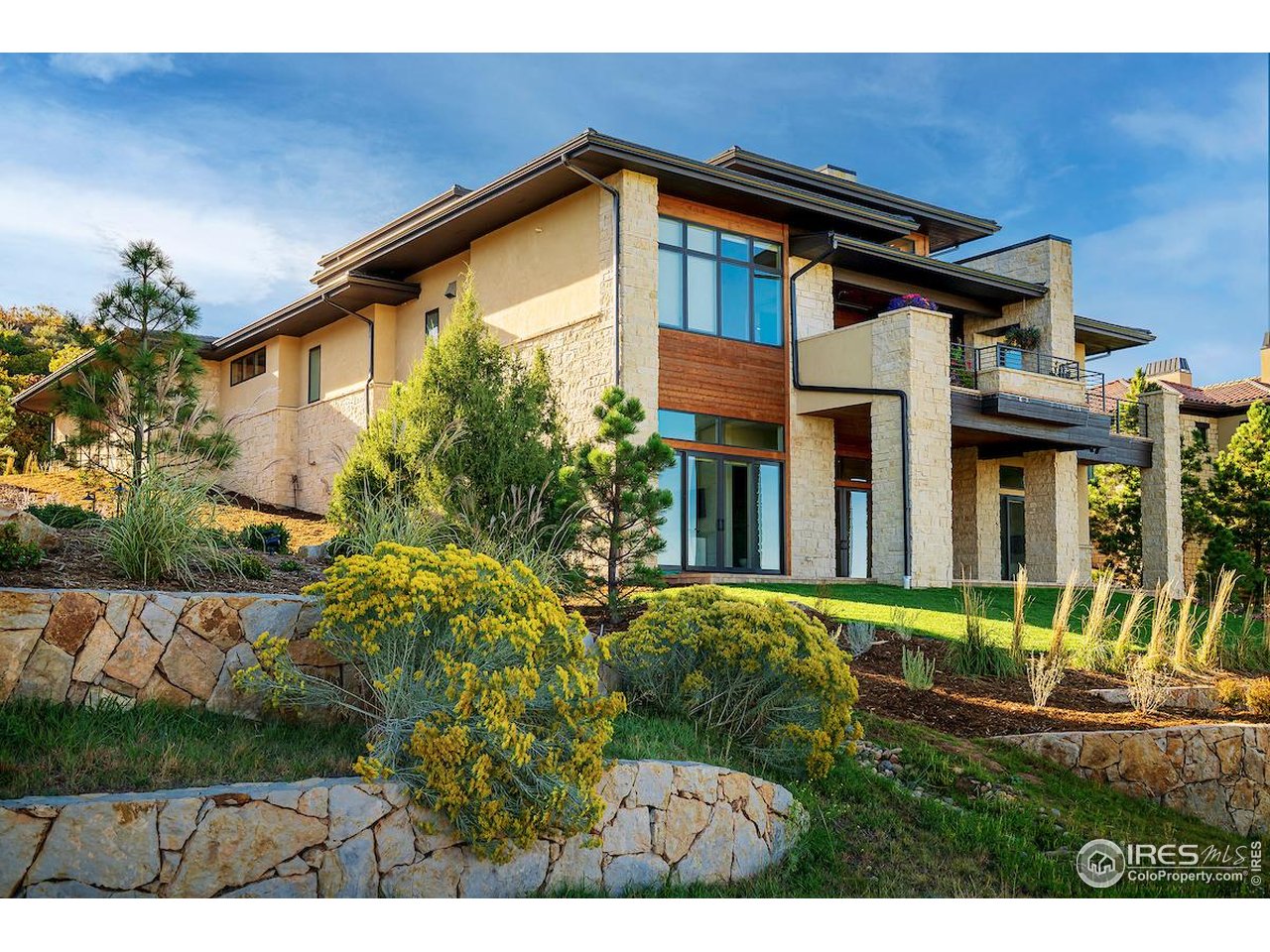 7572 Raphael Lane Littleton, CO 80125 - Photo 2 of 50 Cascading patios and decks and a recent $100,000 investment into the back landscaping provide a series of outdoor living and entertaining zones that embrace the breathtaking natural surroundings.