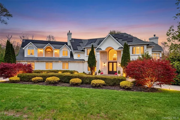 a front view of house with yard and outdoor seating