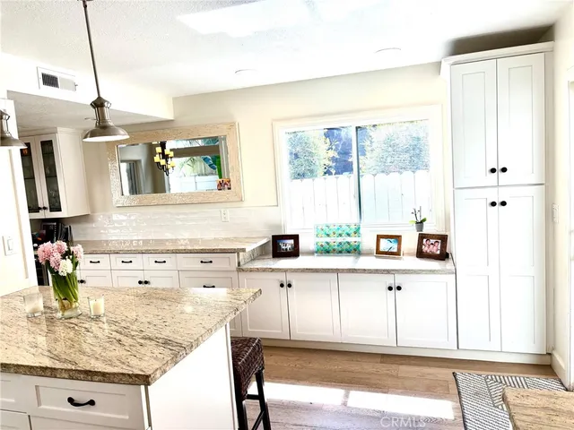 a kitchen with a window a sink and cabinets