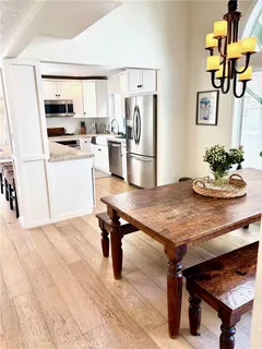 a kitchen with a table chairs and refrigerator