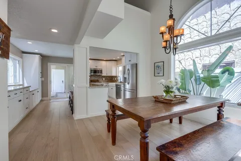 a workspace with furniture wooden floor and a large window