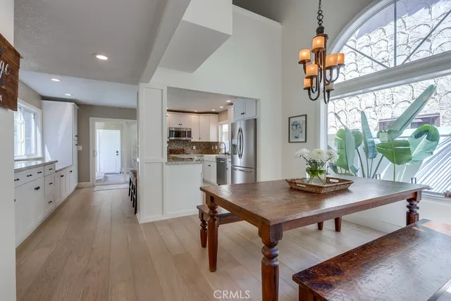 a workspace with furniture wooden floor and a large window
