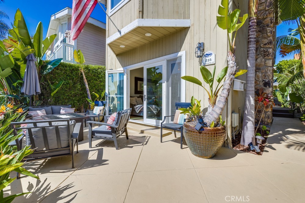 225 20th Street Huntington Beach, CA 92648 - Photo 2 of 47 a view of a backyard with plants and chairs